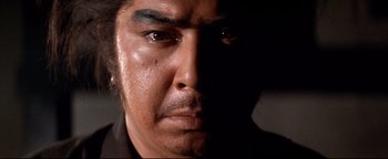Movie still from “Shogun Assassin” (1980), directed by Kenji Misumi – A man's eyes and face; Extreme Close Up shot, Low angle