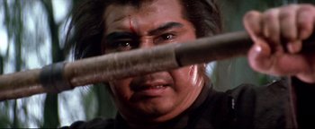 Movie still from “Shogun Assassin” (1980), directed by Kenji Misumi – A person holding a baseball bat; Close Up shot, Low angle