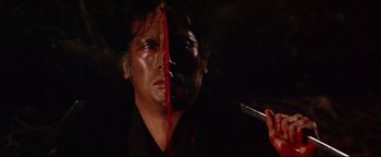 Movie still from “Shogun Assassin” (1980), directed by Kenji Misumi – A person holding a cigarette in their mouth; Close Up shot, Overhead angle