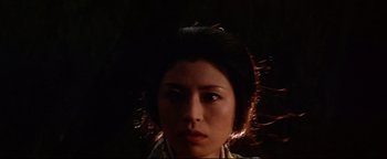 Movie still from “Shogun Assassin” (1980), directed by Kenji Misumi – A young woman is looking into the camera; Close Up shot, Low angle