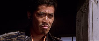 Movie still from “Shogun Assassin” (1980), directed by Kenji Misumi – A person with a beard looking at the camera; Close Up shot, Low angle