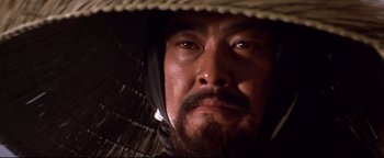 Movie still from “Shogun Assassin” (1980), directed by Kenji Misumi – A person wearing a hat; Close Up shot, Low angle