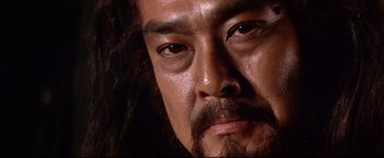 Movie still from “Shogun Assassin” (1980), directed by Kenji Misumi – A man with a beard and mustache; Close Up shot, Low angle