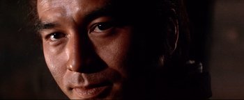 Movie still from “Shogun Assassin” (1980), directed by Kenji Misumi – A man's face in the dark; Extreme Close Up shot, Low angle