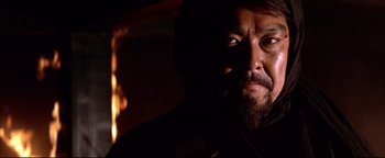 Movie still from “Shogun Assassin” (1980), directed by Kenji Misumi – A person with a beard in the dark; Close Up shot, Low angle