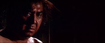 Movie still from “Shogun Assassin” (1980), directed by Kenji Misumi – A man's face in a dark room; Close Up shot, Low angle
