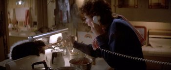 Movie still from “Short Circuit” (1986), directed by John Badham – A woman on the phone in a kitchen; Close Up shot, High angle