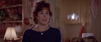 Movie still from “Short Circuit” (1986), directed by John Badham – A person wearing a necklace; Close Up shot, Over the shoulder angle