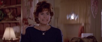 Movie still from “Short Circuit” (1986), directed by John Badham – A person wearing a necklace; Close Up shot, Over the shoulder angle