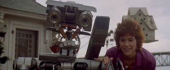 Movie still from “Short Circuit” (1986), directed by John Badham – A person is sitting in front of a laptop computer; Close Up shot, Low angle