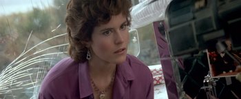 Movie still from “Short Circuit” (1986), directed by John Badham – A person wearing a purple shirt; Close Up shot, Over the shoulder angle