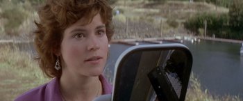 Movie still from “Short Circuit” (1986), directed by John Badham – A person in a car mirror; Close Up shot, Over the shoulder angle