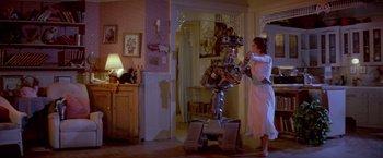 Movie still from “Short Circuit” (1986), directed by John Badham – A woman in a white dress standing in front of a robot; Wide shot, Low angle