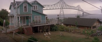 Movie still from “Short Circuit” (1986), directed by John Badham – A group of geese in a yard near a house; Extreme Wide shot, High angle