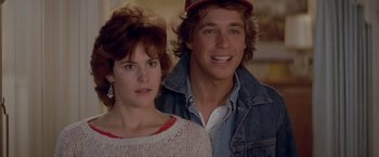 Movie still from “Short Circuit” (1986), directed by John Badham – A man and a woman standing next to each other; Close Up shot, Over the shoulder angle