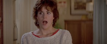 Movie still from “Short Circuit” (1986), directed by John Badham – A person wearing a sweater with her mouth wide open; Close Up shot, Over the shoulder angle