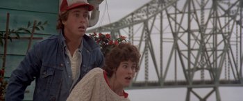 Movie still from “Short Circuit” (1986), directed by John Badham – A man and a woman standing next to each other on a bridge; Close Up shot, Low angle