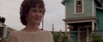 Movie still from “Short Circuit” (1986), directed by John Badham – A person wearing a sweater near a building; Close Up shot, Over the shoulder angle