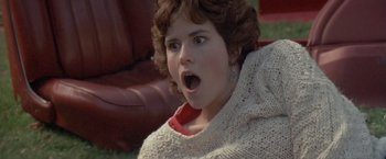 Movie still from “Short Circuit” (1986), directed by John Badham – A young woman with a surprised look on her face; Close Up shot, High angle