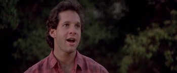 Movie still from “Short Circuit” (1986), directed by John Badham – A person wearing a red and white shirt; Close Up shot, Low angle