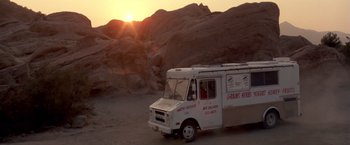 Movie still from “Short Circuit” (1986), directed by John Badham – An ice cream truck parked on the side of the road; Extreme Wide shot, High angle