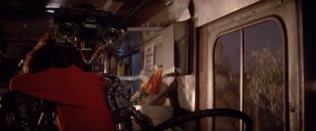 Movie still from “Short Circuit” (1986), directed by John Badham – A person holding a camera; Close Up shot, Low angle