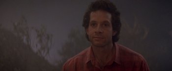 Movie still from “Short Circuit” (1986), directed by John Badham – A person wearing a red shirt; Close Up shot, Low angle