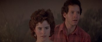 Movie still from “Short Circuit” (1986), directed by John Badham – A man and a woman standing next to each other; Close Up shot, Low angle