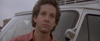 Movie still from “Short Circuit” (1986), directed by John Badham – A person wearing a red shirt looking at the camera; Close Up shot, Low angle