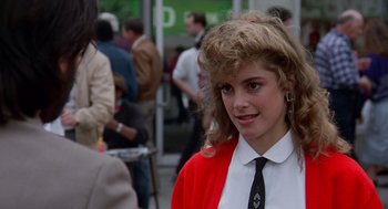 Movie still from “Short Circuit 2” (1988), directed by Kenneth Johnson – A woman in a red jacket and black tie; Close Up shot, Over the shoulder angle