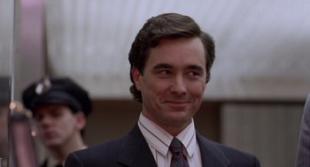 Movie still from “Short Circuit 2” (1988), directed by Kenneth Johnson – A person wearing a suit and tie; Close Up shot, Low angle