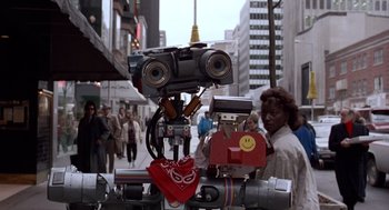 Movie still from “Short Circuit 2” (1988), directed by Kenneth Johnson – People walking down the street in a city; Close Up shot, Low angle