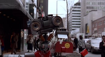 Movie still from “Short Circuit 2” (1988), directed by Kenneth Johnson – A robot with a camera attached to it's head; Close Up shot, Low angle