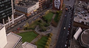 Movie still from “Short Circuit 2” (1988), directed by Kenneth Johnson – An aerial view of a park in the middle of a city; Extreme Wide shot, High angle