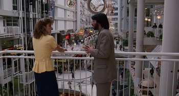 Movie still from “Short Circuit 2” (1988), directed by Kenneth Johnson – A man and a woman standing next to a railing; Wide shot, High angle