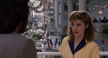 Movie still from “Short Circuit 2” (1988), directed by Kenneth Johnson – A woman talking to another woman in a city; Medium shot, Over the shoulder angle