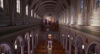Movie still from “Short Circuit 2” (1988), directed by Kenneth Johnson – An old church with a lot of pews in it; Extreme Wide shot, High angle
