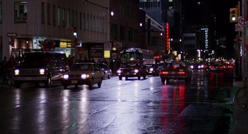 Movie still from “Short Circuit 2” (1988), directed by Kenneth Johnson – A city street filled with lots of traffic at night; Extreme Wide shot, High angle