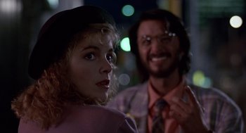 Movie still from “Short Circuit 2” (1988), directed by Kenneth Johnson – A man and a woman standing next to each other; Close Up shot, Over the shoulder angle