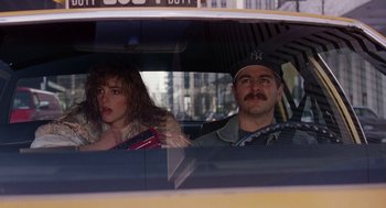 Movie still from “Short Circuit 2” (1988), directed by Kenneth Johnson – A man and a woman sitting in a car; Medium shot, Over the shoulder angle