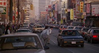 Movie still from “Short Circuit 2” (1988), directed by Kenneth Johnson – A busy city street filled with lots of traffic; Extreme Wide shot, High angle