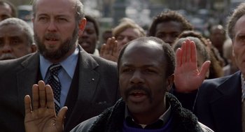 Movie still from “Short Circuit 2” (1988), directed by Kenneth Johnson – A group of people standing in front of each other; Close Up shot, Low angle