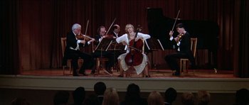 Movie still from “Short Cuts” (1993), directed by Robert Altman – A group of people on a stage playing musical instruments; Wide shot, High angle
