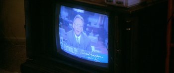 Movie still from “Short Cuts” (1993), directed by Robert Altman – An old television with a picture of a man on it; Extreme Close Up shot, Over the shoulder angle