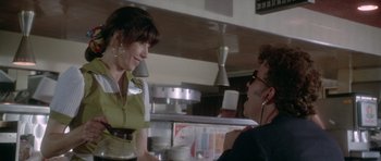 Movie still from “Short Cuts” (1993), directed by Robert Altman – A man and a woman in a kitchen talking to each other; Medium shot, Over the shoulder angle