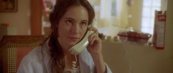 Movie still from “Short Cuts” (1993), directed by Robert Altman – A woman is holding a phone up to her ear; Close Up shot, High angle