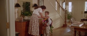 Movie still from “Short Cuts” (1993), directed by Robert Altman – A woman and a young boy in front of a staircase; Wide shot, High angle