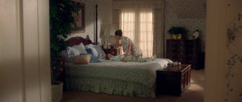 Movie still from “Short Cuts” (1993), directed by Robert Altman – A woman in a white dress is on a bed; Wide shot, High angle