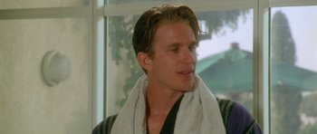 Movie still from “Short Cuts” (1993), directed by Robert Altman – A person with a towel around his neck; Close Up shot, Over the shoulder angle