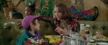 Movie still from “Short Cuts” (1993), directed by Robert Altman – A woman sitting next to a child at a table; Medium shot, Over the shoulder angle